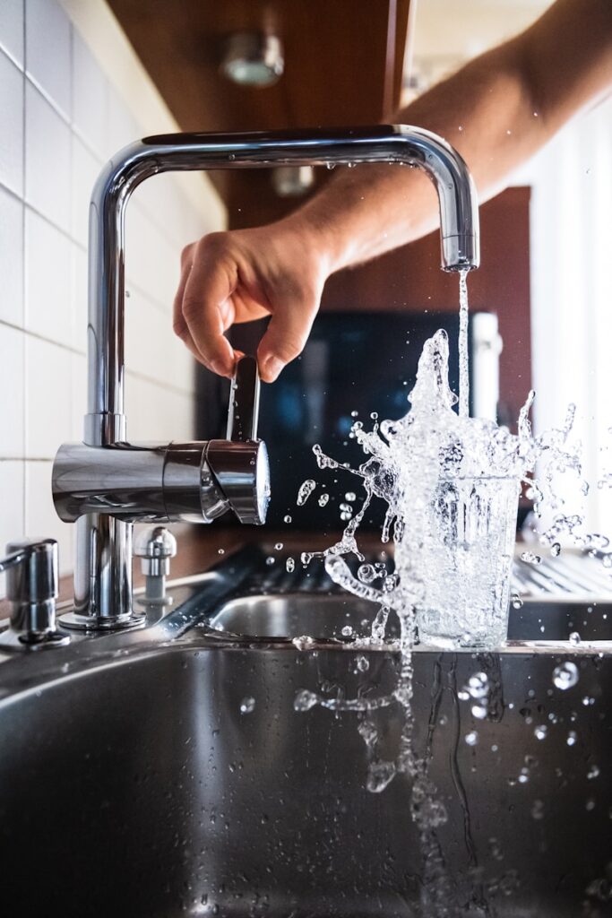 Photo by Jacek Dylag person opening faucet